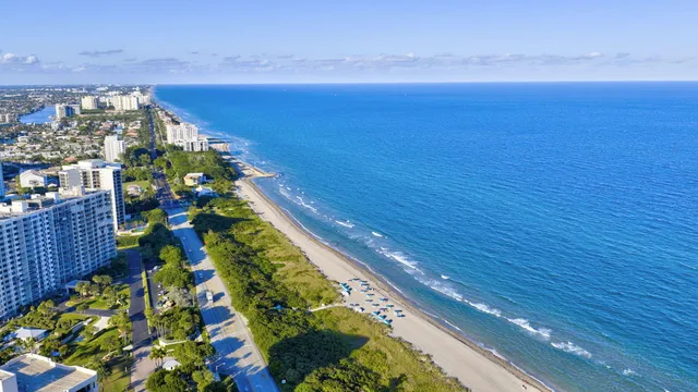 an aerial view of residential houses with outdoor space and lake view