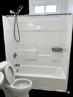 a bathroom with a toilet and a bathtub