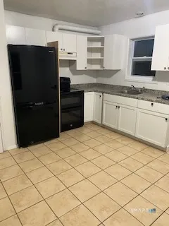 a kitchen with stainless steel appliances kitchen island granite countertop a refrigerator sink and cabinets