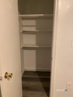 a view of walk in closet with empty racks