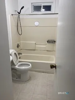 a bathroom with a granite countertop toilet a sink and a shower