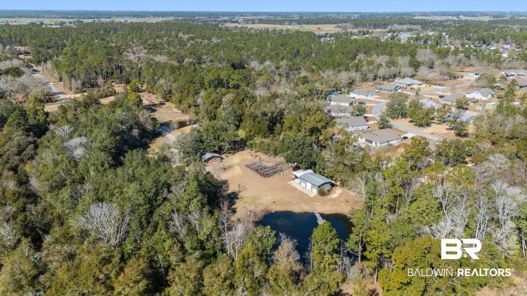 32989 Antietam Road Lillian, AL 36549 - Photo 44 of 56 Aerial view of property's location with a nearby body of water and a forest