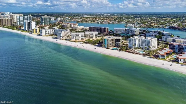 a bedroom with bed and glass window