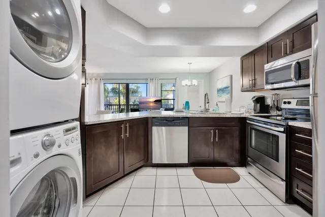 a kitchen with stainless steel appliances granite countertop a sink and cabinets