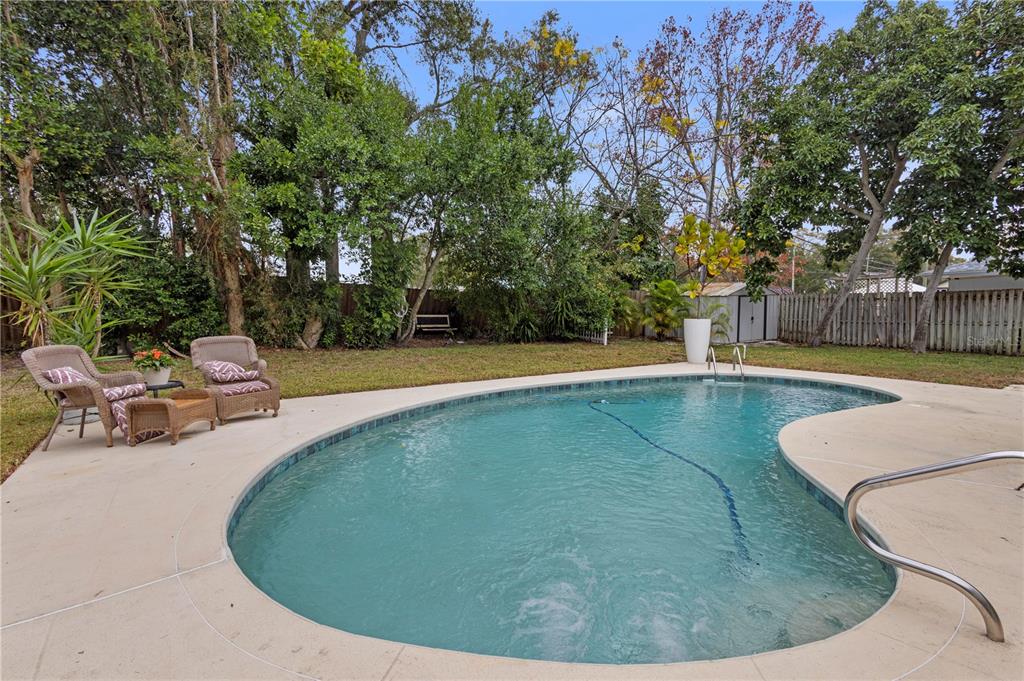 1437 Glenview Road Palm Harbor, FL 34683 - Photo 15 of 69 a view of a swimming pool with a sitting space
