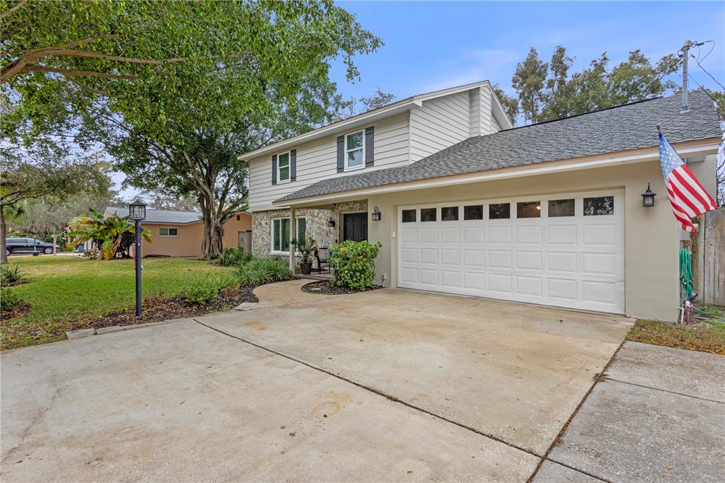 1437 Glenview Road Palm Harbor, FL 34683 - Photo 18 of 69 a front view of a house with a yard and garage