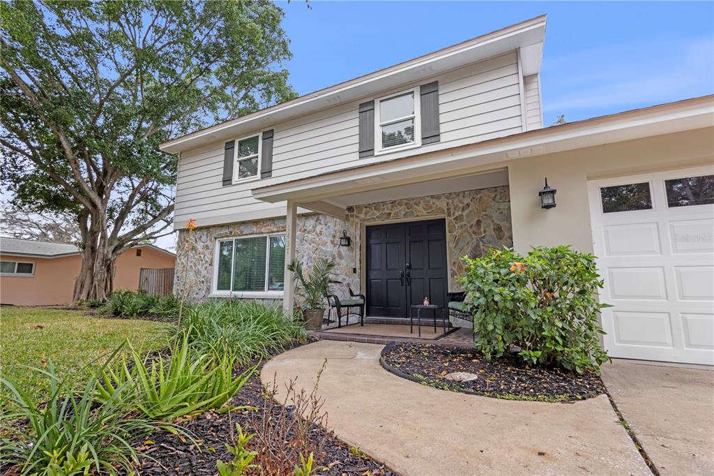 1437 Glenview Road Palm Harbor, FL 34683 - Photo 19 of 69 a front view of a house with a yard