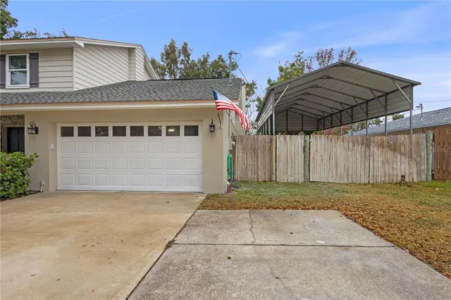 a kitchen with stainless steel appliances granite countertop a dining table chairs stove refrigerator and microwave