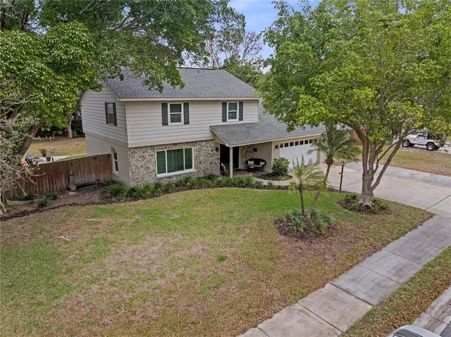a kitchen with granite countertop cabinets stainless steel appliances a sink and a window