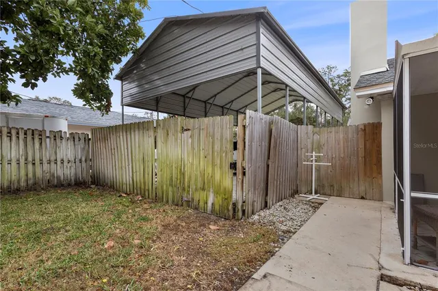 a kitchen with granite countertop a refrigerator and cabinets