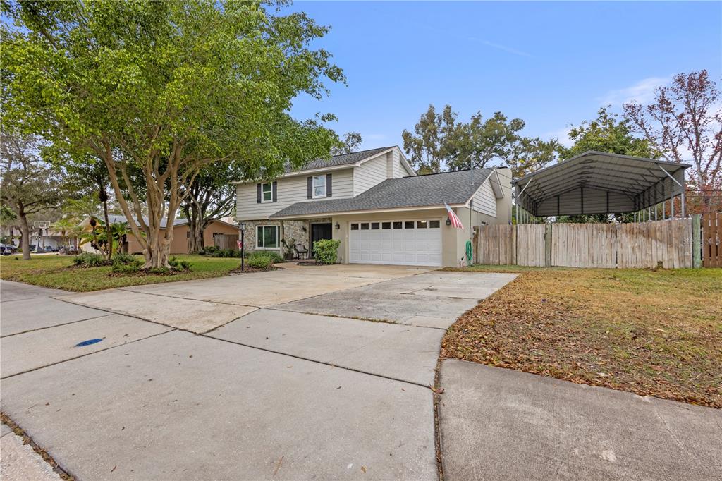 1437 Glenview Road Palm Harbor, FL 34683 - Photo 25 of 69 a front view of a house with a yard