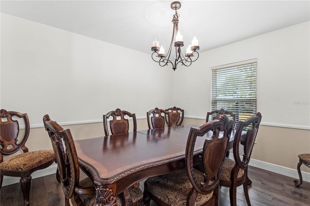 1437 Glenview Road Palm Harbor, FL 34683 - Photo 30 of 69 a view of a dining room with furniture window and wooden floor