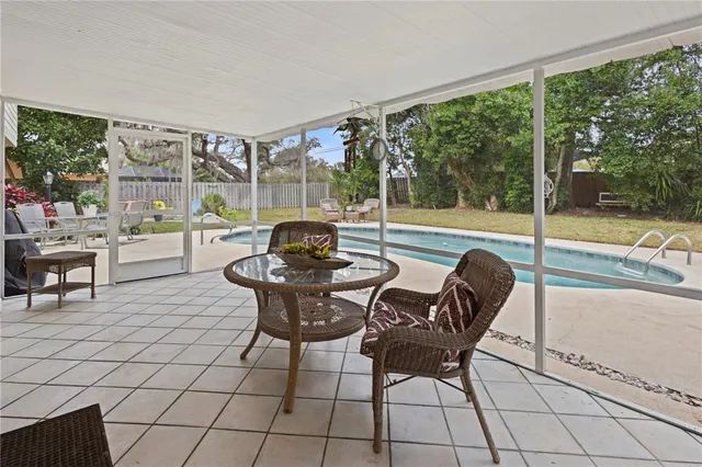 a view of a house with swimming pool and porch