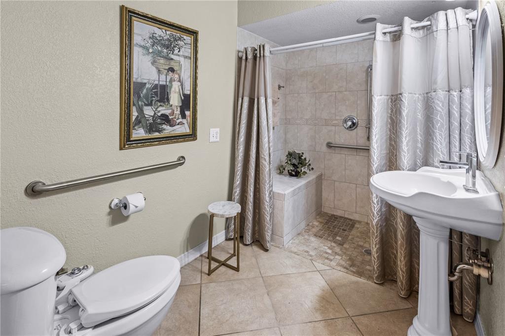 1437 Glenview Road Palm Harbor, FL 34683 - Photo 37 of 69 a white toilet sitting next to a bathroom sink