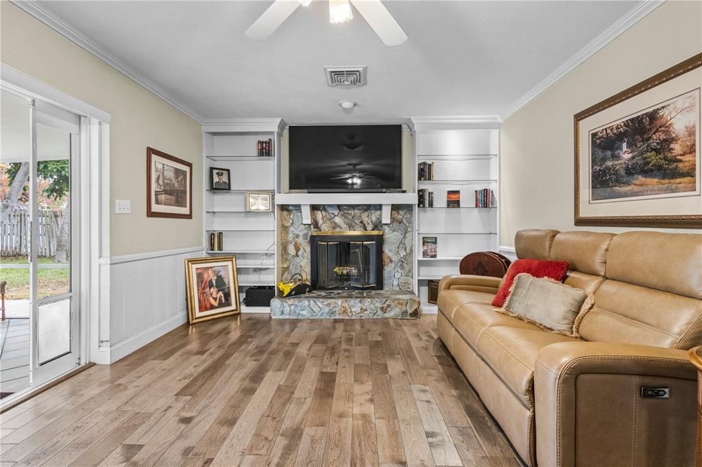 1437 Glenview Road Palm Harbor, FL 34683 - Photo 39 of 69 a living room with furniture and a fireplace