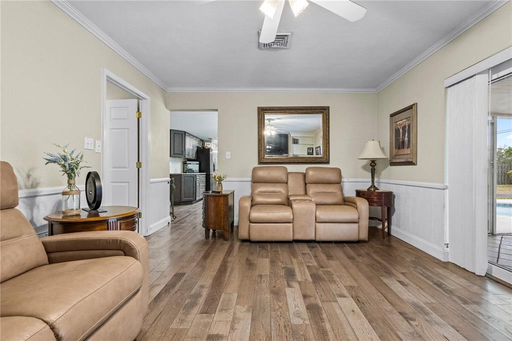 1437 Glenview Road Palm Harbor, FL 34683 - Photo 42 of 69 a living room with furniture and a wooden floor