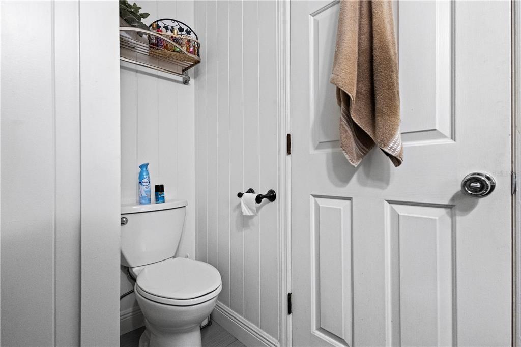 1437 Glenview Road Palm Harbor, FL 34683 - Photo 56 of 69 a bathroom with a toilet sink and mirror