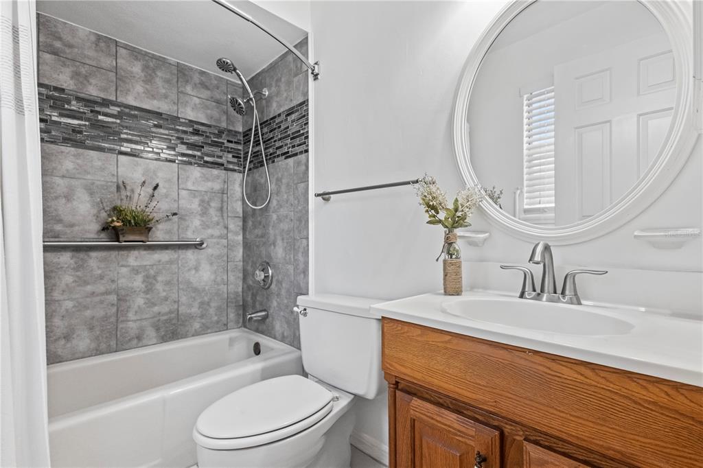 1437 Glenview Road Palm Harbor, FL 34683 - Photo 61 of 69 a bathroom with a sink a toilet and shower