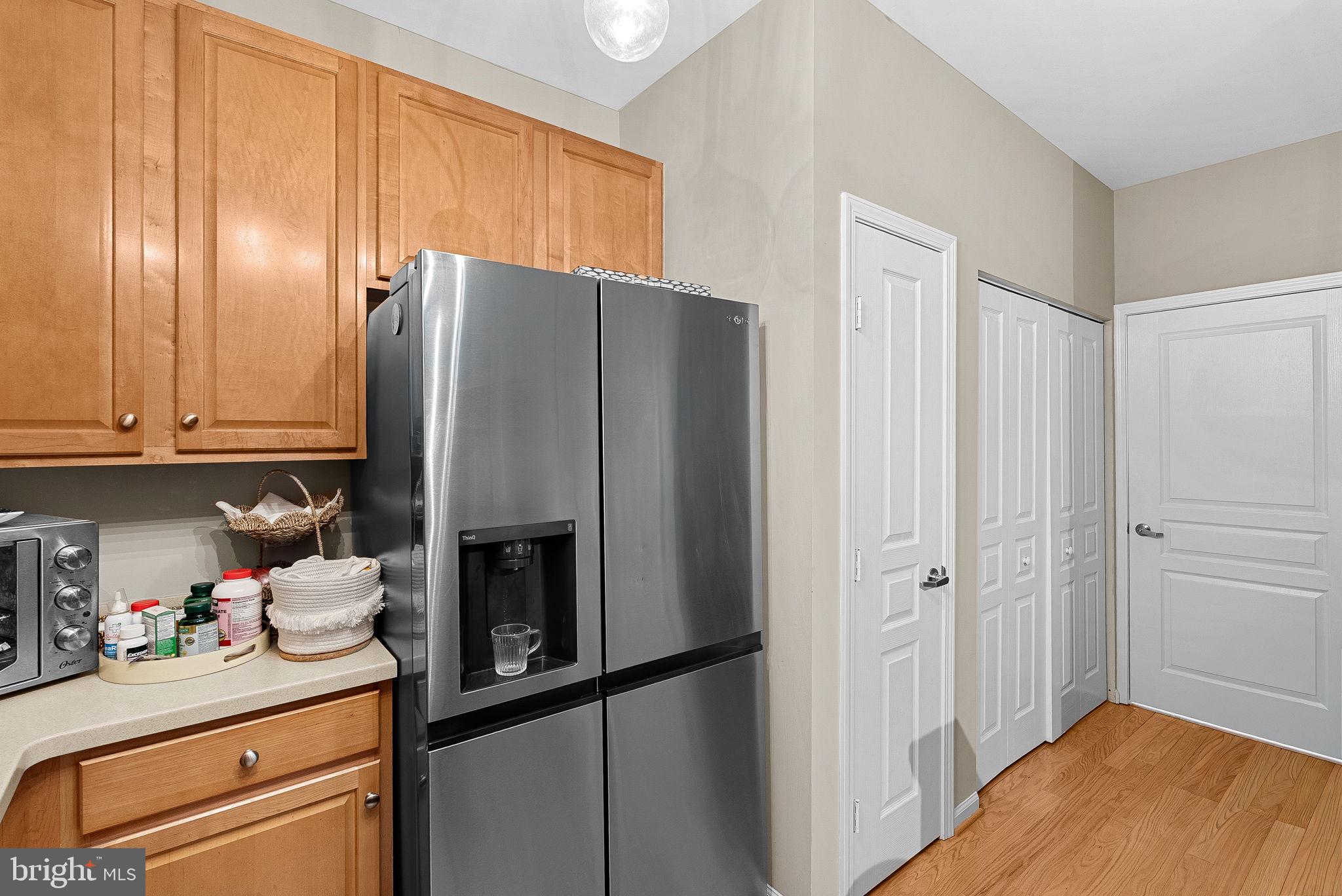 12001 Market Street, Unit 106 Reston, VA 20190 - Photo 17 of 45 a kitchen with stainless steel appliances granite countertop a refrigerator and a stove top oven