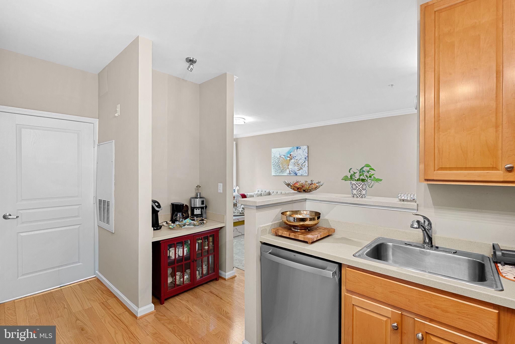 12001 Market Street, Unit 106 Reston, VA 20190 - Photo 18 of 45 a kitchen with a cabinets and window