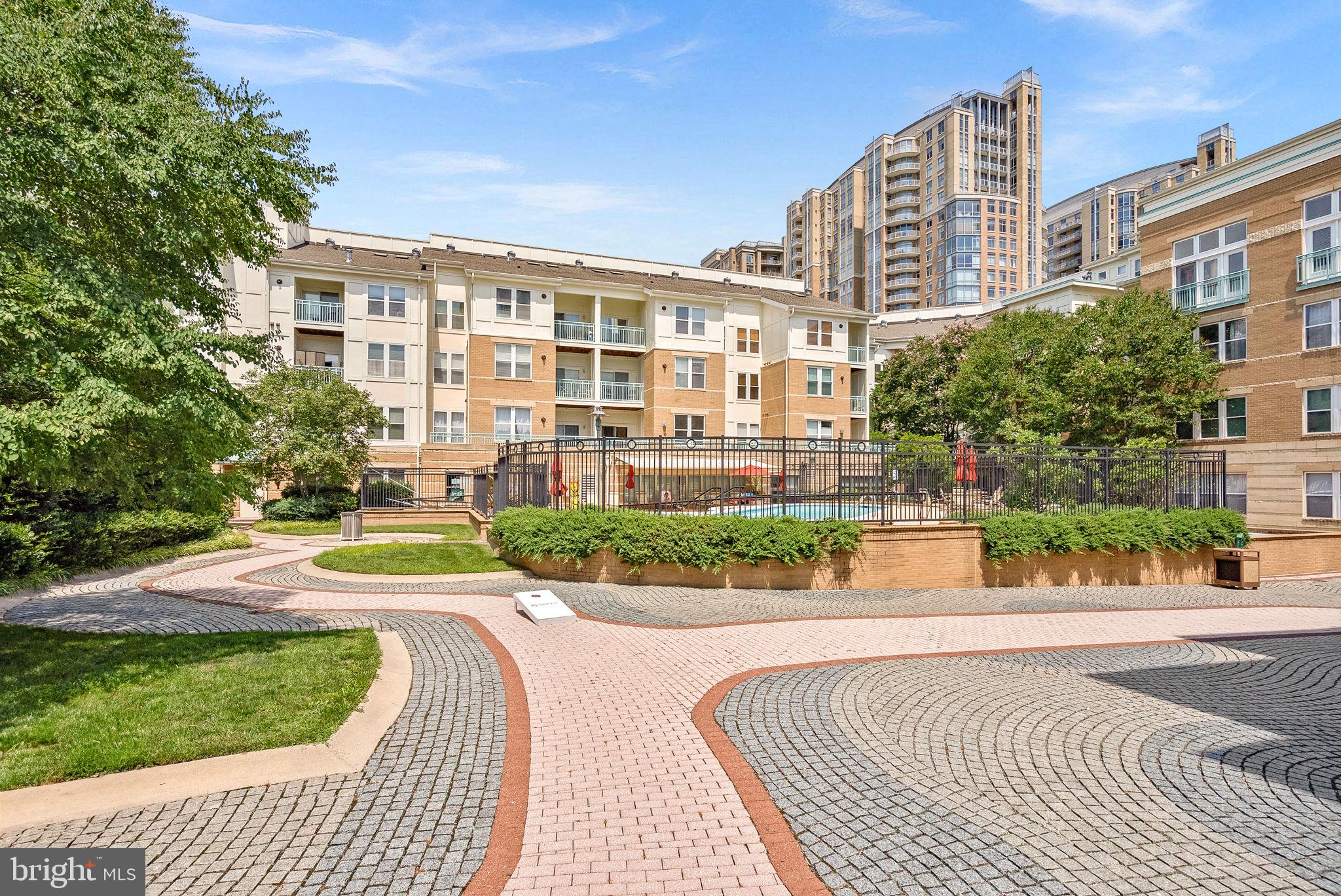 12001 Market Street, Unit 106 Reston, VA 20190 - Photo 37 of 45 a view of a brick building next to a yard