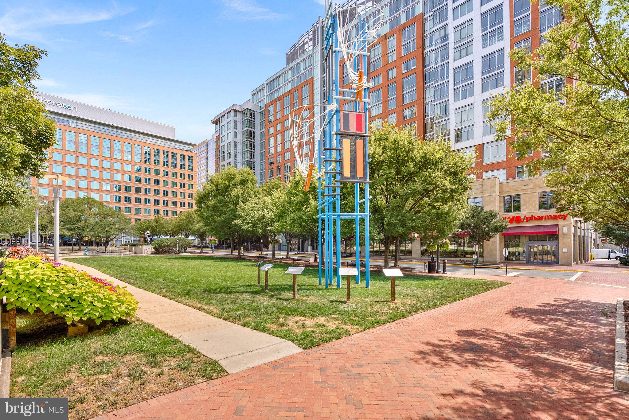 12001 Market Street, Unit 106 Reston, VA 20190 - Photo 39 of 45 a front view of a building with garden and trees