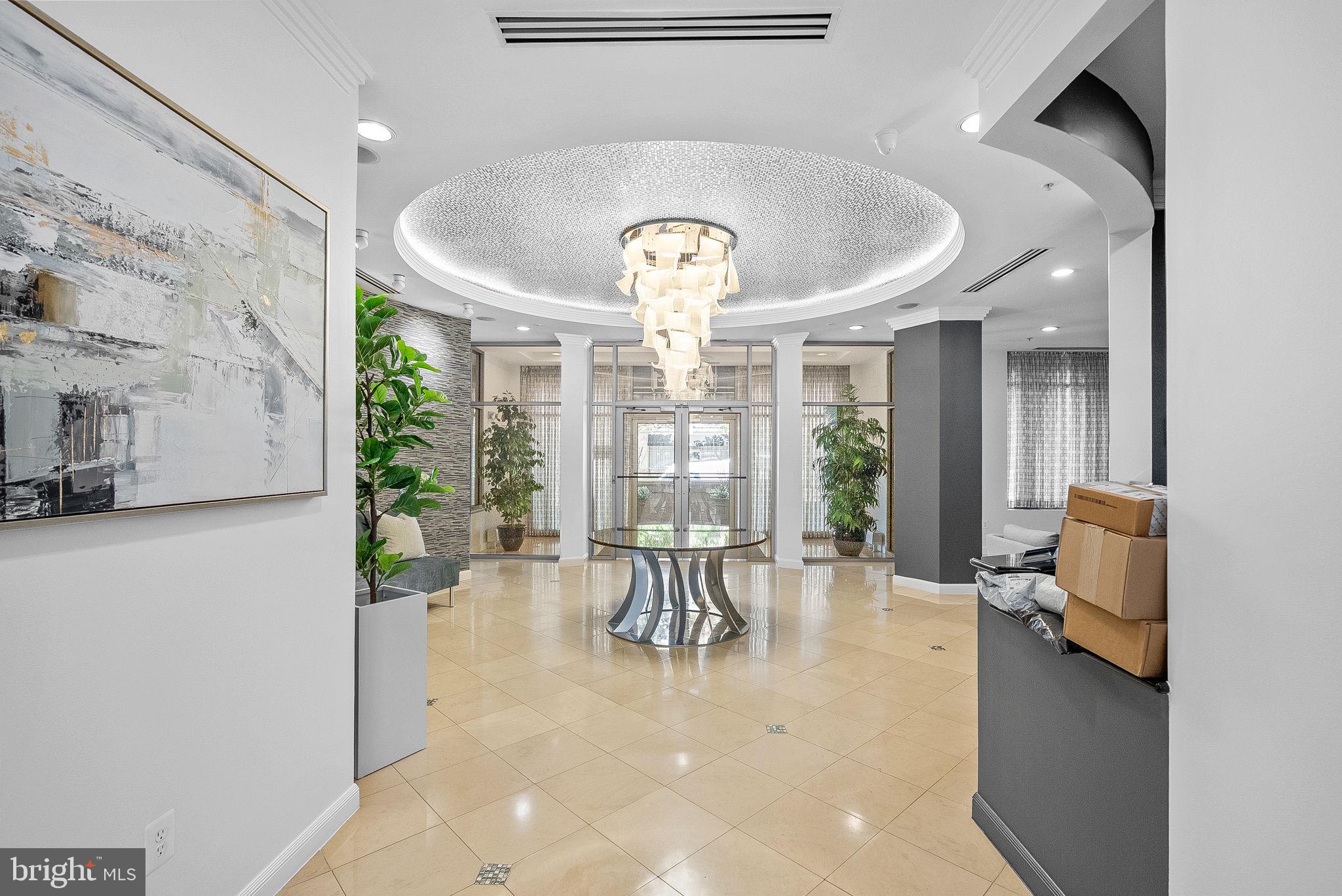 12001 Market Street, Unit 106 Reston, VA 20190 - Photo 4 of 45 a view of a lobby with furniture and chandelier
