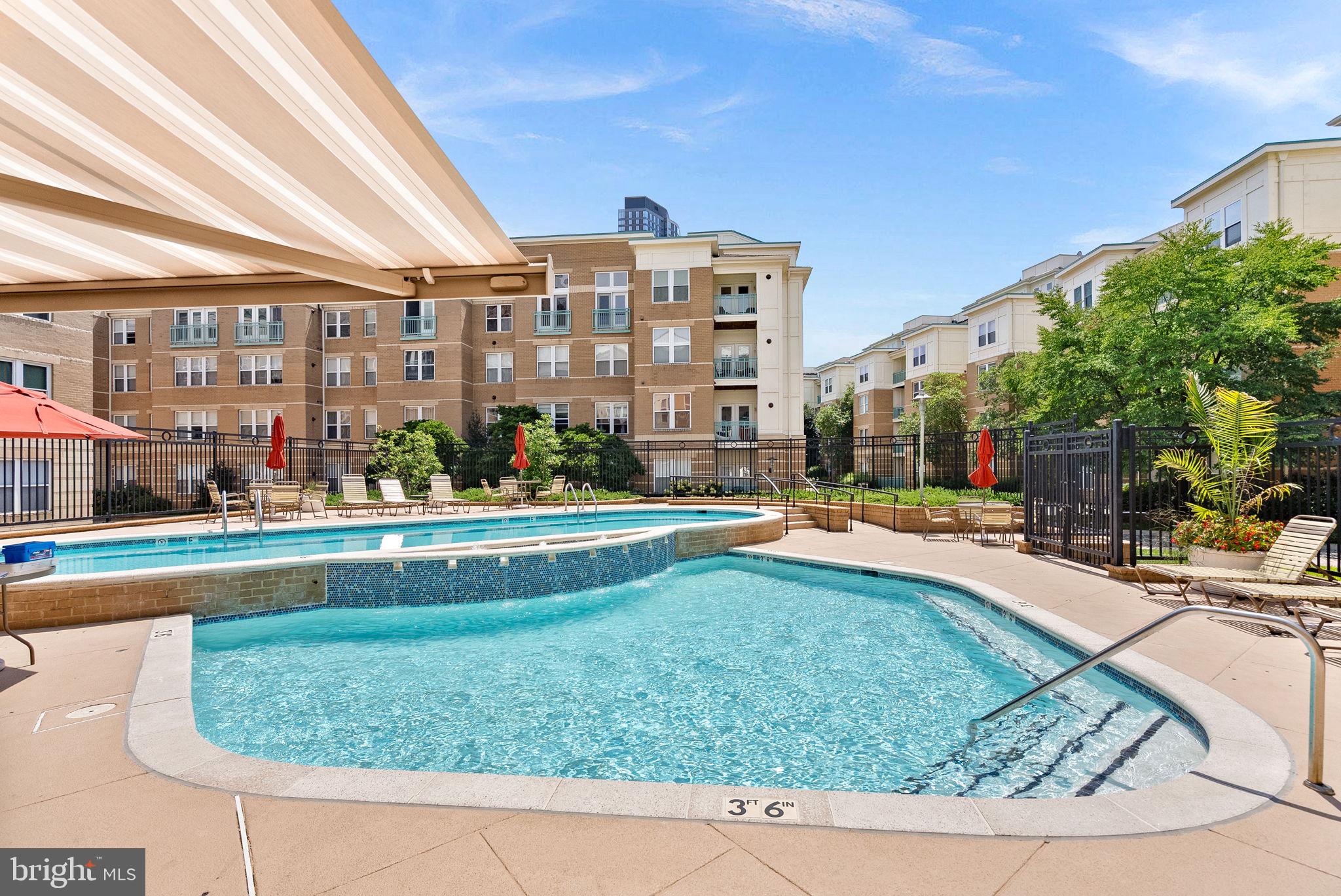 12001 Market Street, Unit 106 Reston, VA 20190 - Photo 43 of 45 a view of swimming pool with outdoor seating and plants