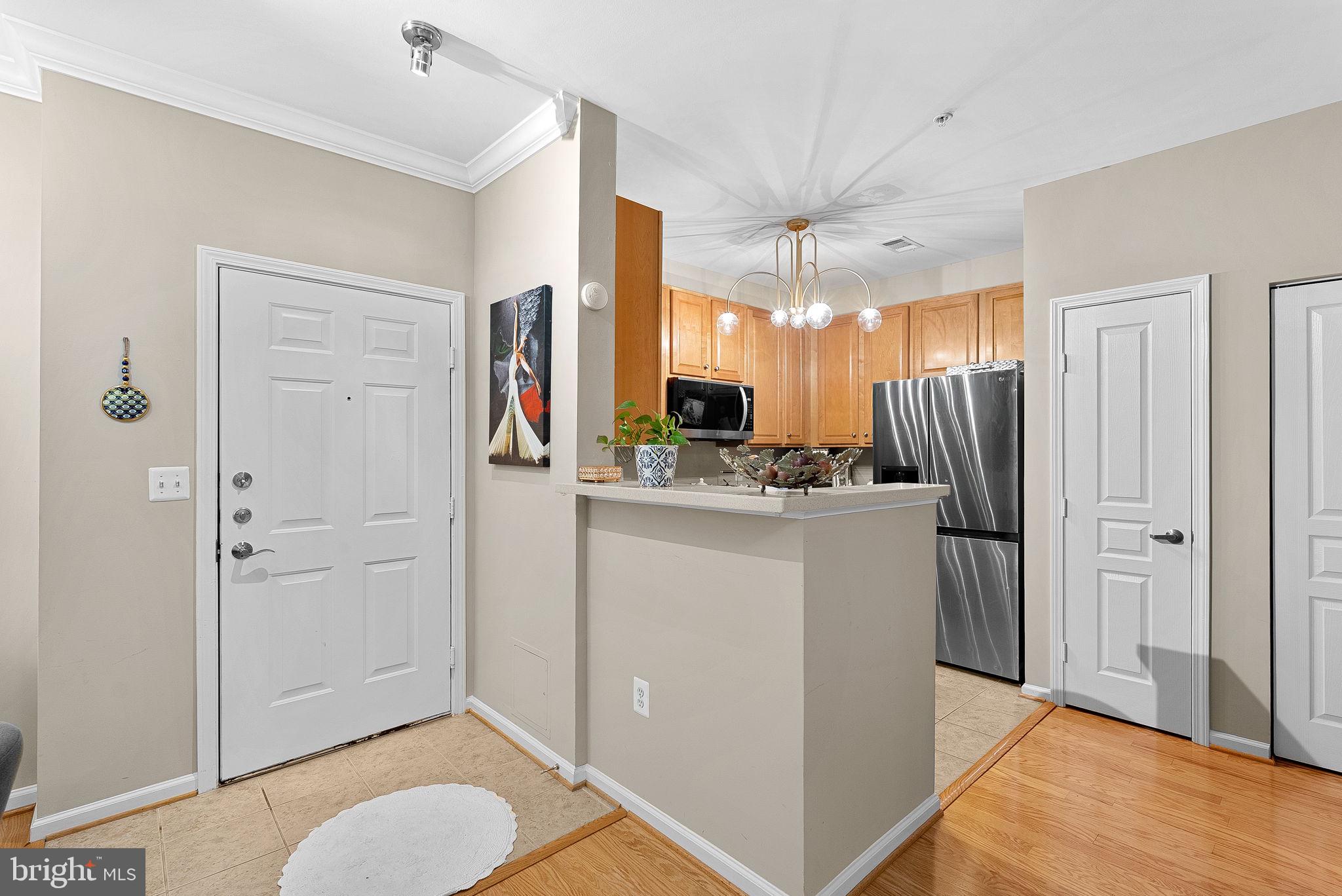 12001 Market Street, Unit 106 Reston, VA 20190 - Photo 6 of 45 a bathroom with a refrigerator and a sink