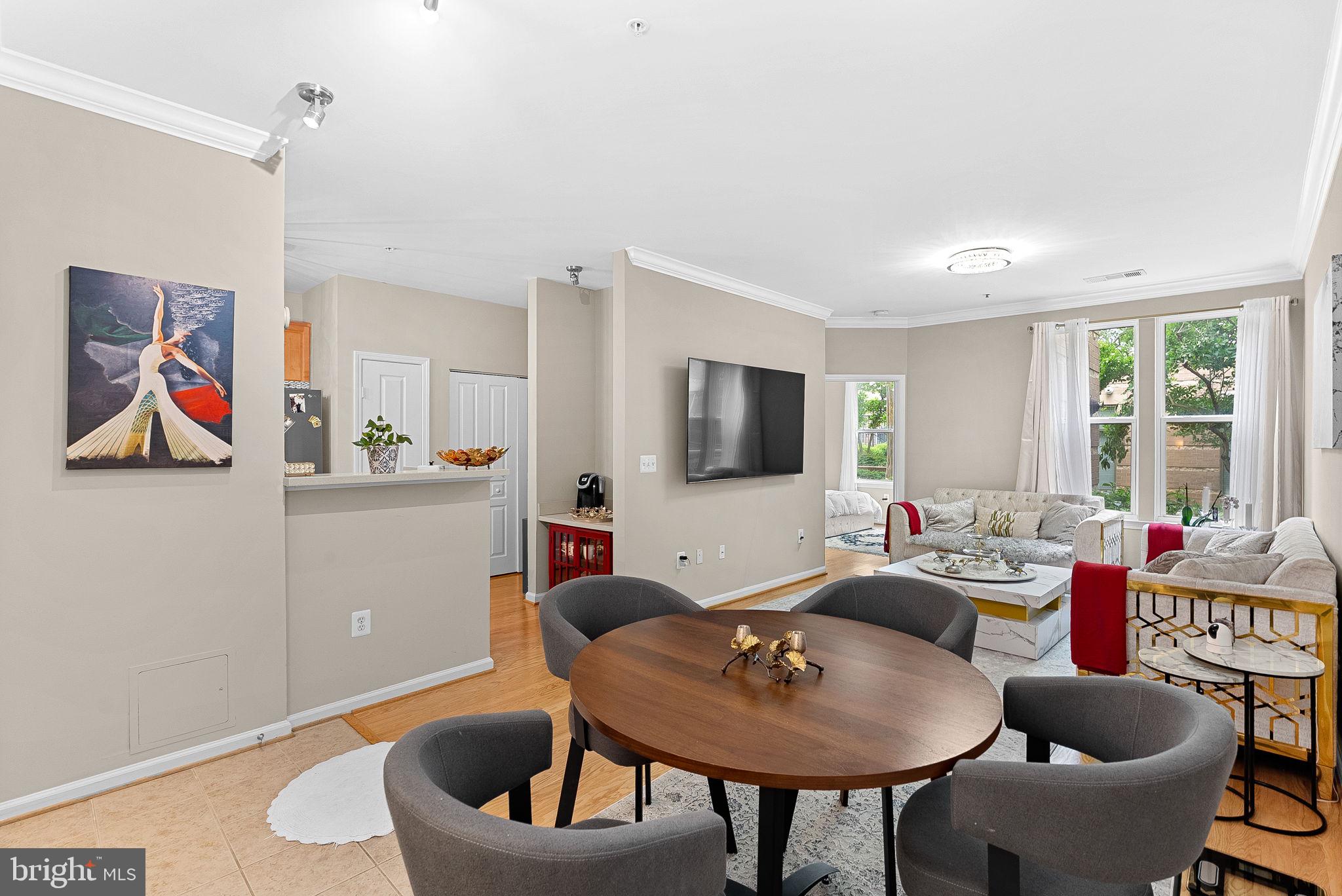 12001 Market Street, Unit 106 Reston, VA 20190 - Photo 9 of 45 a living room with furniture and a flat screen tv
