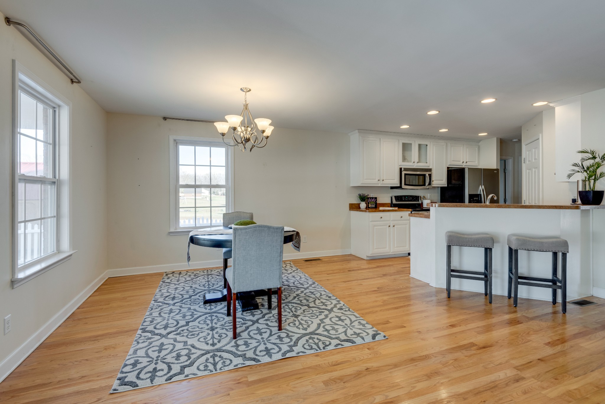 423 Pruett Road Dickson, TN 37055 - Photo 20 of 36 a living room with dining table wooden floor and kitchen view