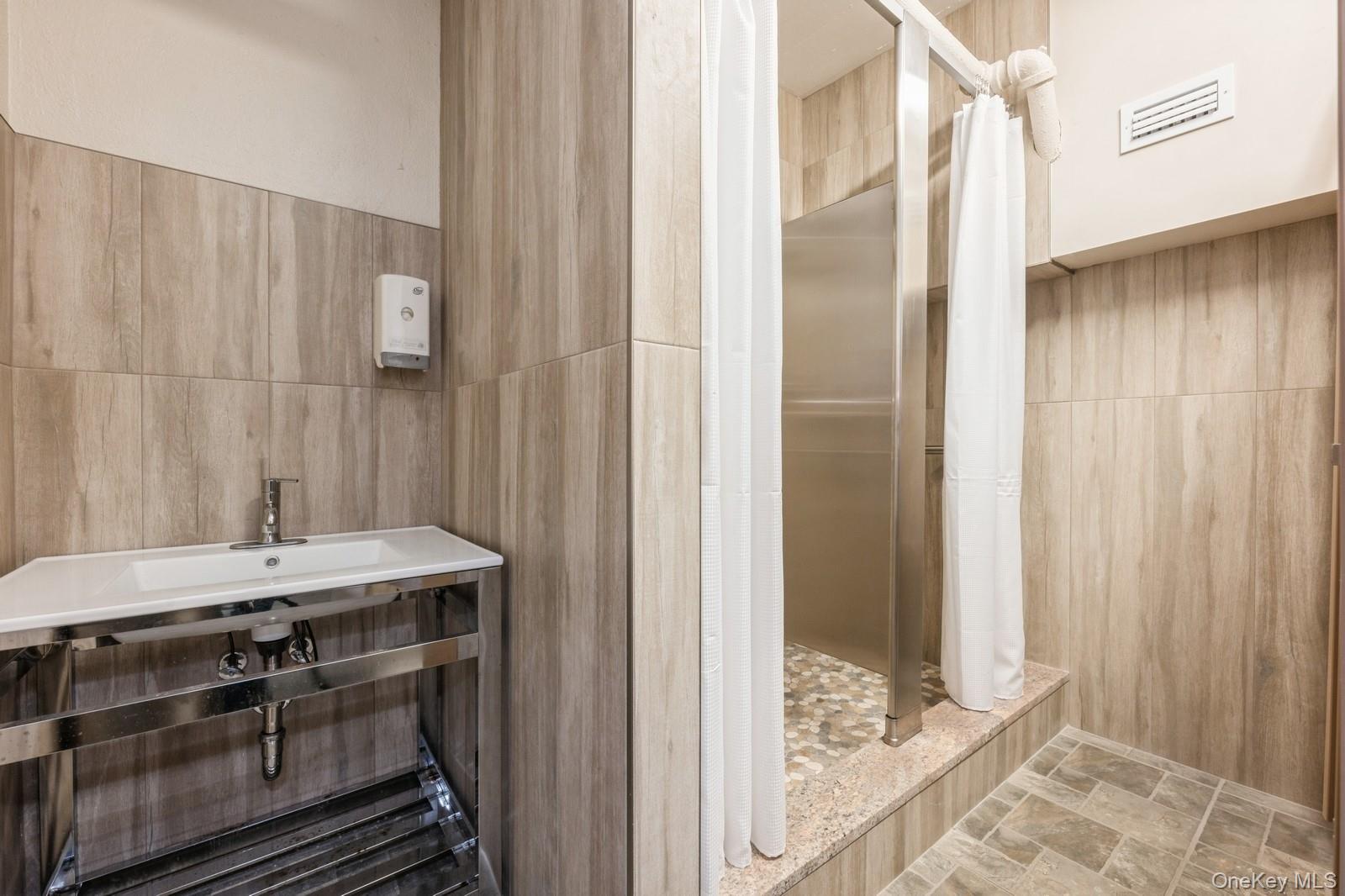700 Shore Road, Unit 4O Long Beach, NY 11561 - Photo 33 of 42 a bathroom with a sink and a mirror