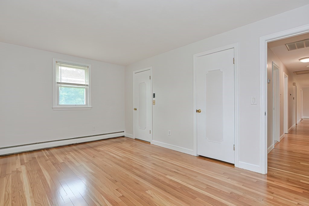 11 Bellwood Way Framingham, MA 01701 - Photo 17 of 42 a view of an empty room with wooden floor and a window