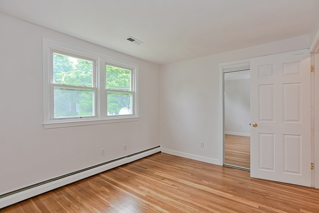 11 Bellwood Way Framingham, MA 01701 - Photo 19 of 42 a view of empty room with wooden floor and fan