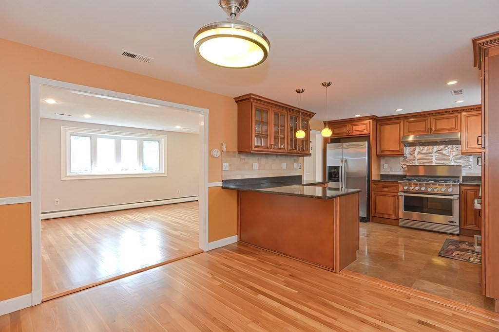 11 Bellwood Way Framingham, MA 01701 - Photo 2 of 42 a kitchen with stainless steel appliances granite countertop a stove a sink and a refrigerator
