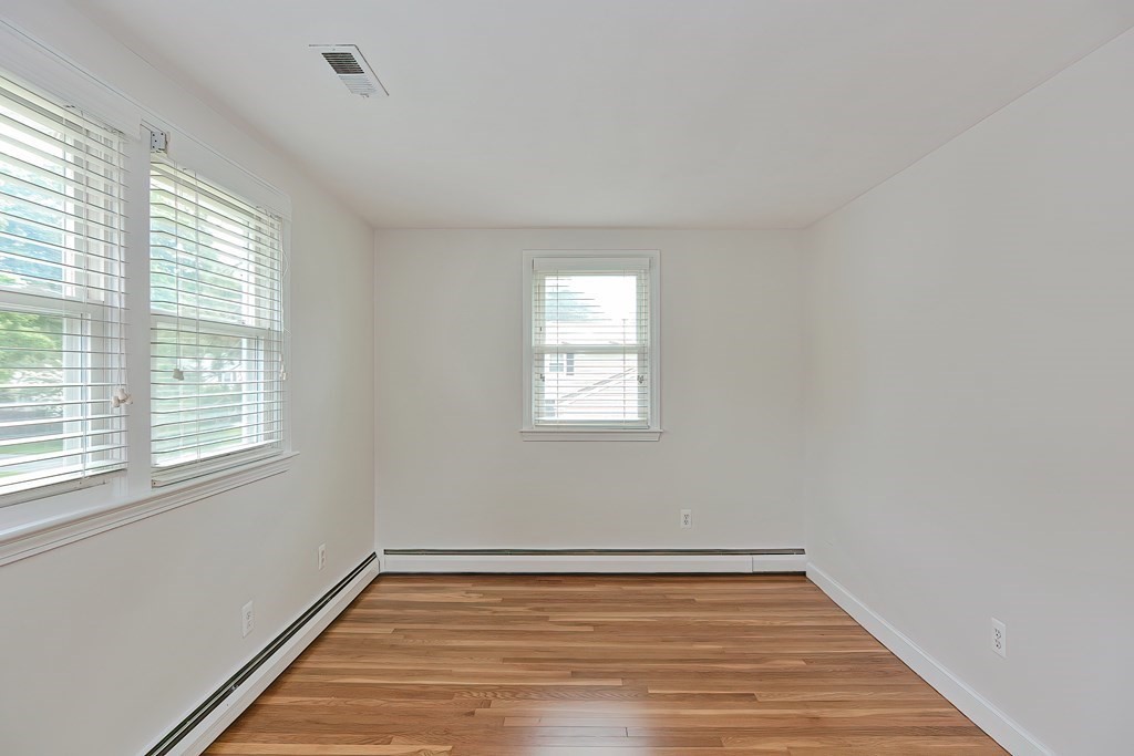 11 Bellwood Way Framingham, MA 01701 - Photo 21 of 42 a view of an empty room with wooden floor and a window