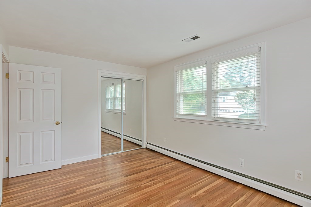 11 Bellwood Way Framingham, MA 01701 - Photo 22 of 42 a view of an empty room with wooden floor and a window