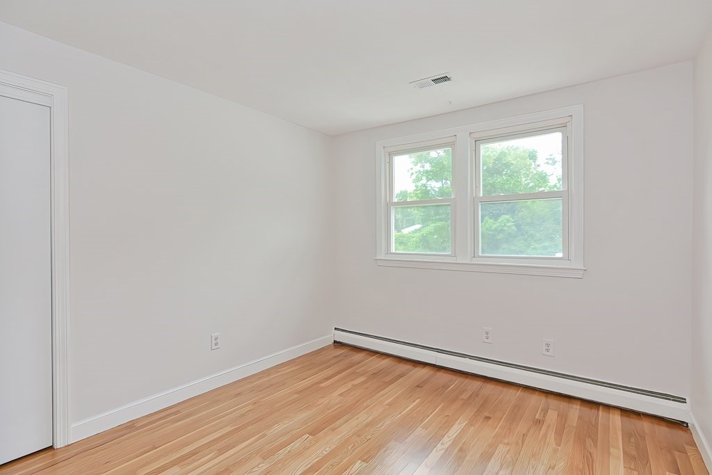 11 Bellwood Way Framingham, MA 01701 - Photo 30 of 42 an empty room with wooden floor and windows