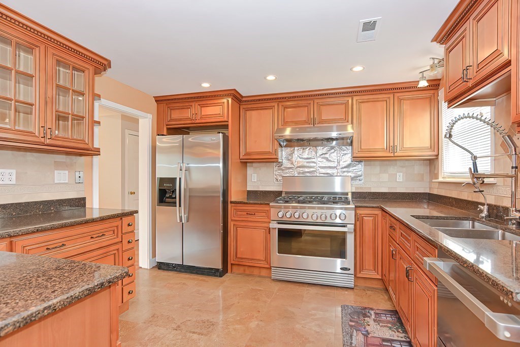 11 Bellwood Way Framingham, MA 01701 - Photo 4 of 42 a kitchen with stainless steel appliances granite countertop a stove and a sink