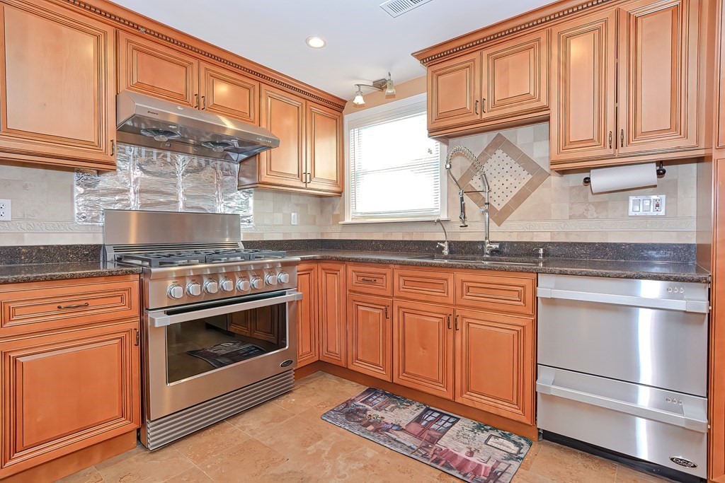 11 Bellwood Way Framingham, MA 01701 - Photo 5 of 42 a kitchen with granite countertop stainless steel appliances a stove sink and cabinets