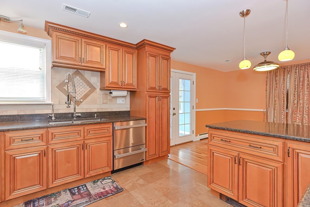 11 Bellwood Way Framingham, MA 01701 - Photo 6 of 42 a kitchen with stainless steel appliances granite countertop a sink a stove cabinets and a window