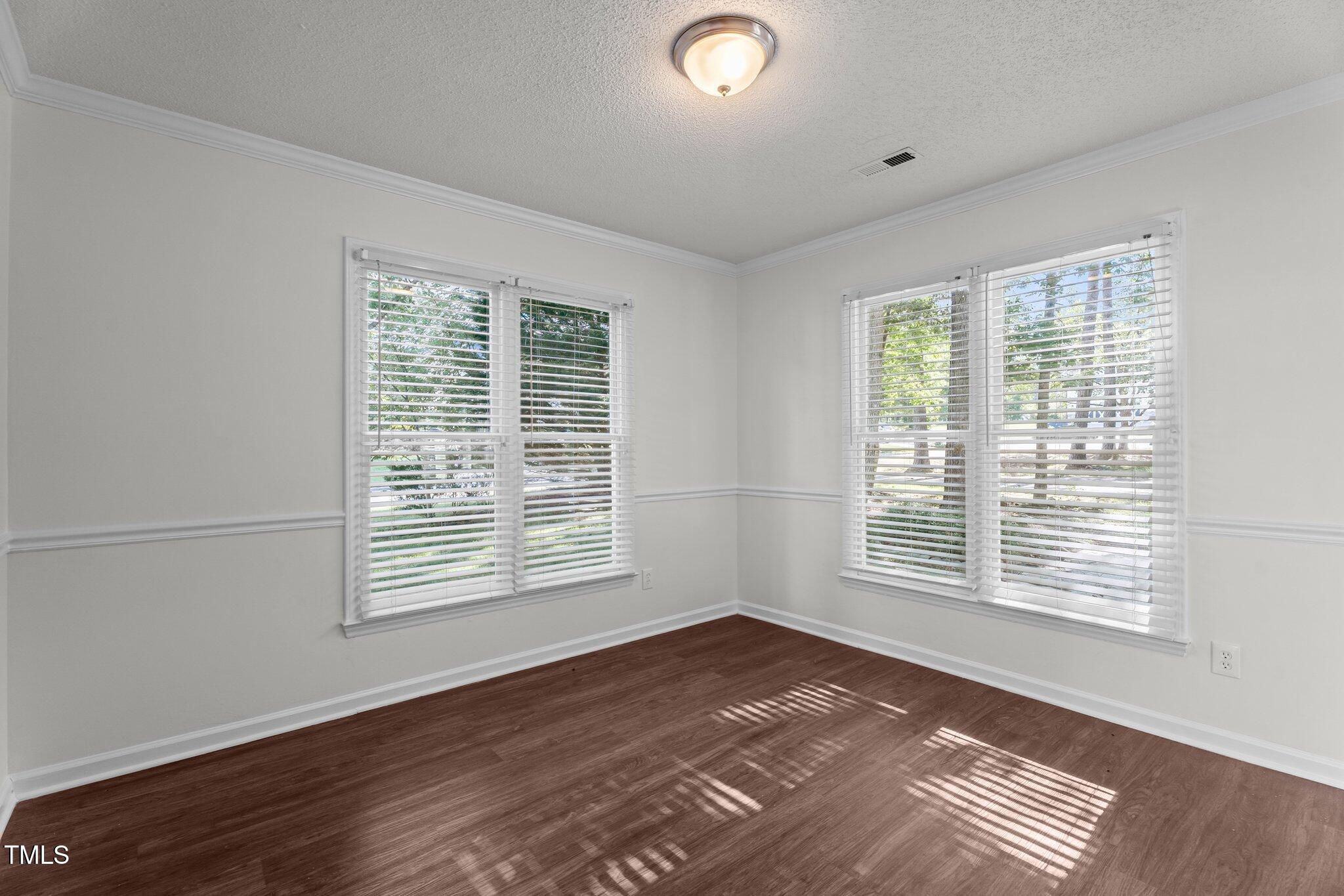 3624 Singleleaf Lane Raleigh, NC 27616 - Photo 13 of 40 a view of an empty room with wooden floor and a window