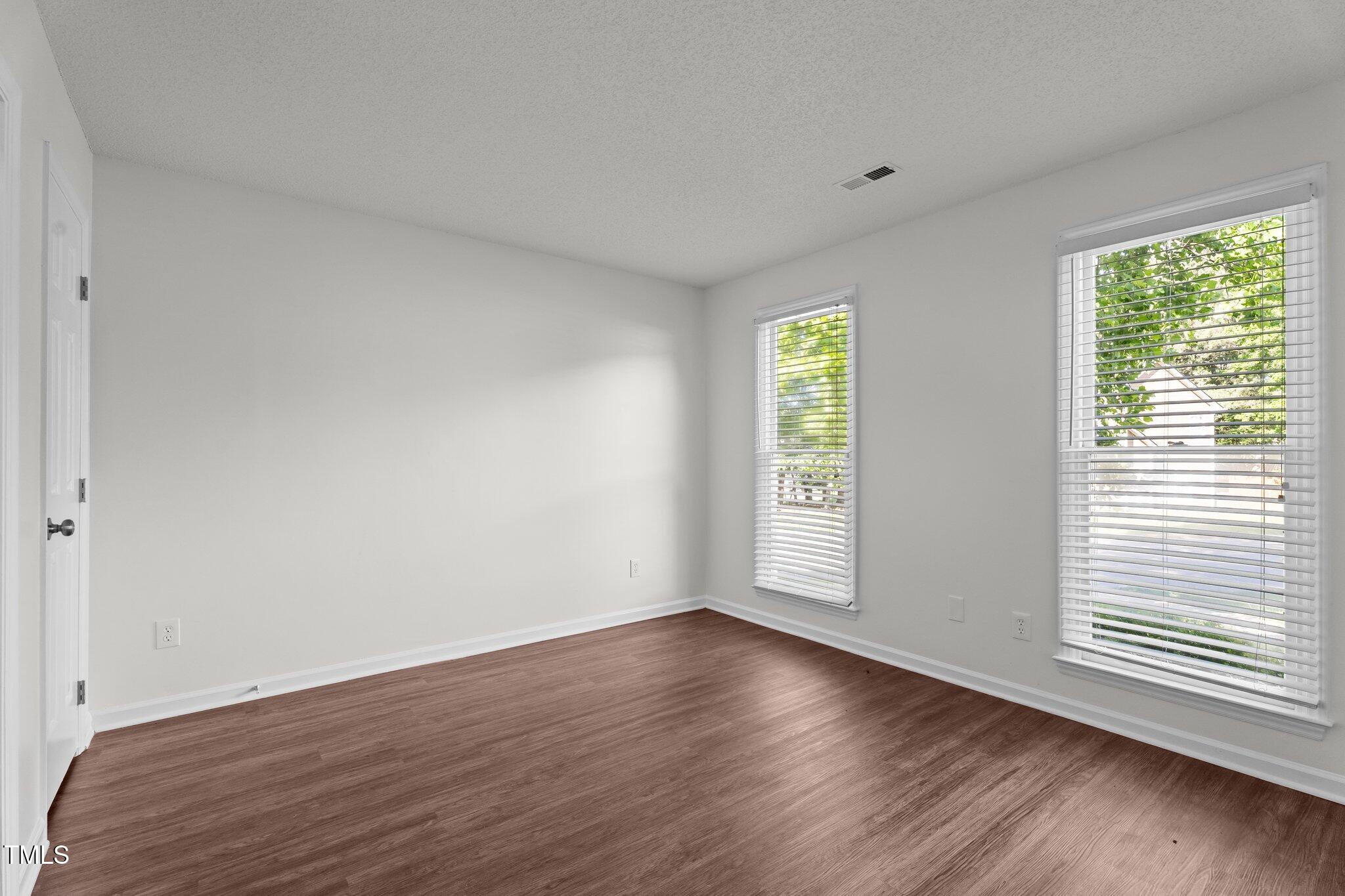 3624 Singleleaf Lane Raleigh, NC 27616 - Photo 23 of 40 a view of an empty room with wooden floor and a window