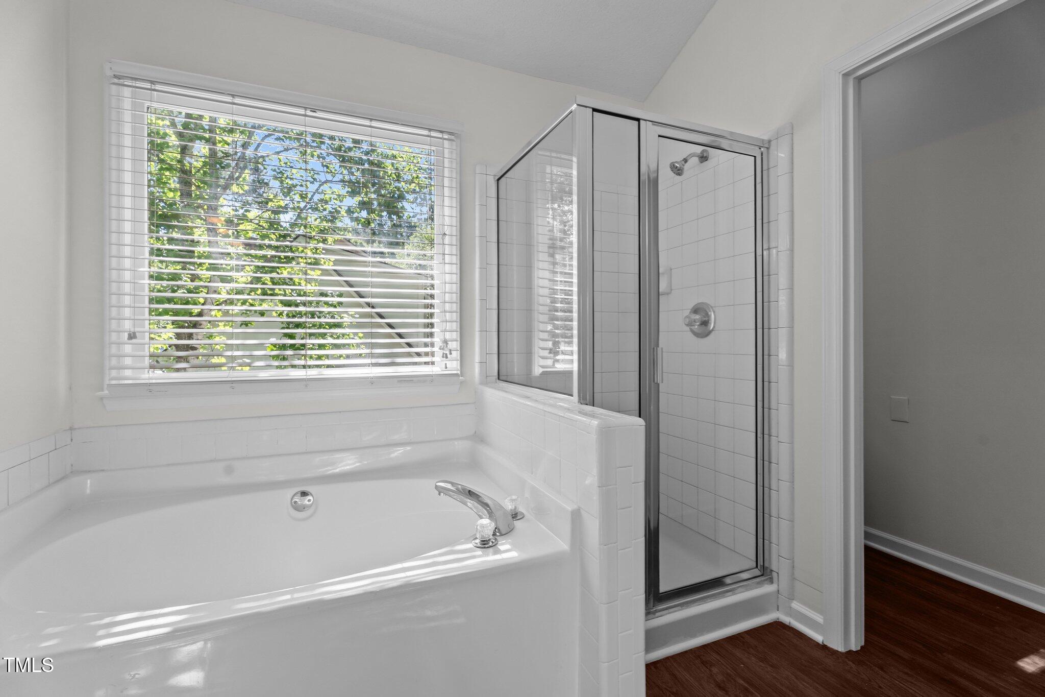 3624 Singleleaf Lane Raleigh, NC 27616 - Photo 32 of 40 a bathroom with a bathtub a shower and a window