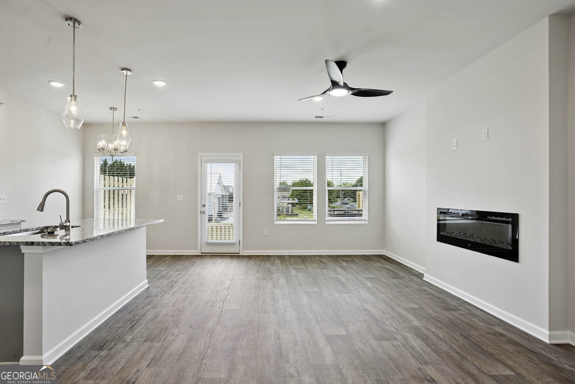 11516 Kimberly Way Hampton, GA 30228 - Photo 13 of 39 a view of a kitchen with a sink wooden floor and a window