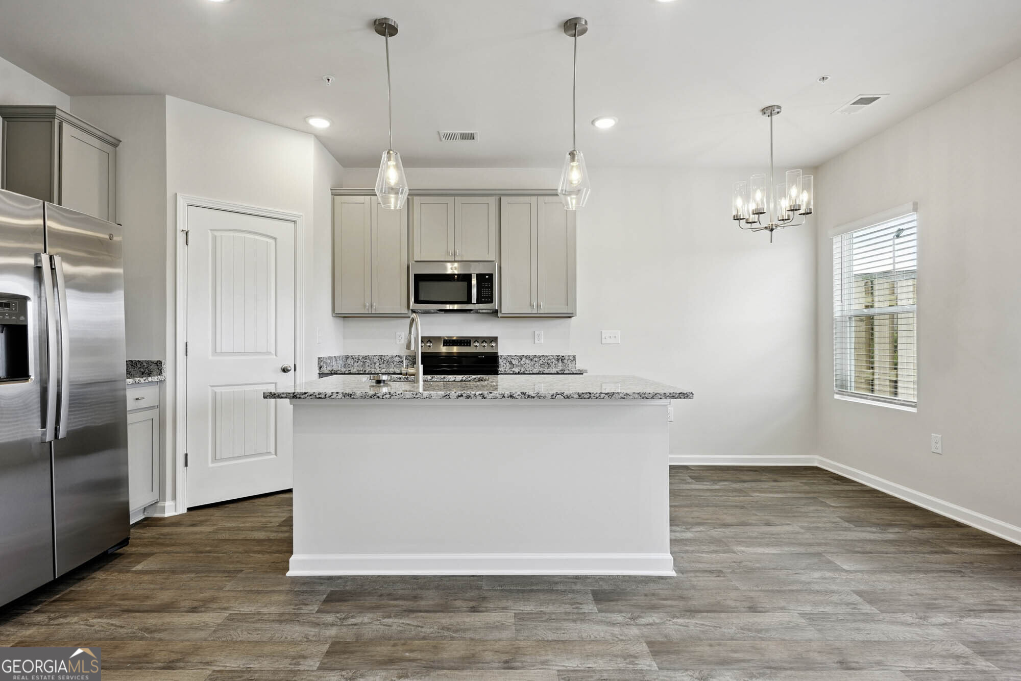 11516 Kimberly Way Hampton, GA 30228 - Photo 14 of 39 a kitchen with kitchen island a counter top space appliances and cabinets