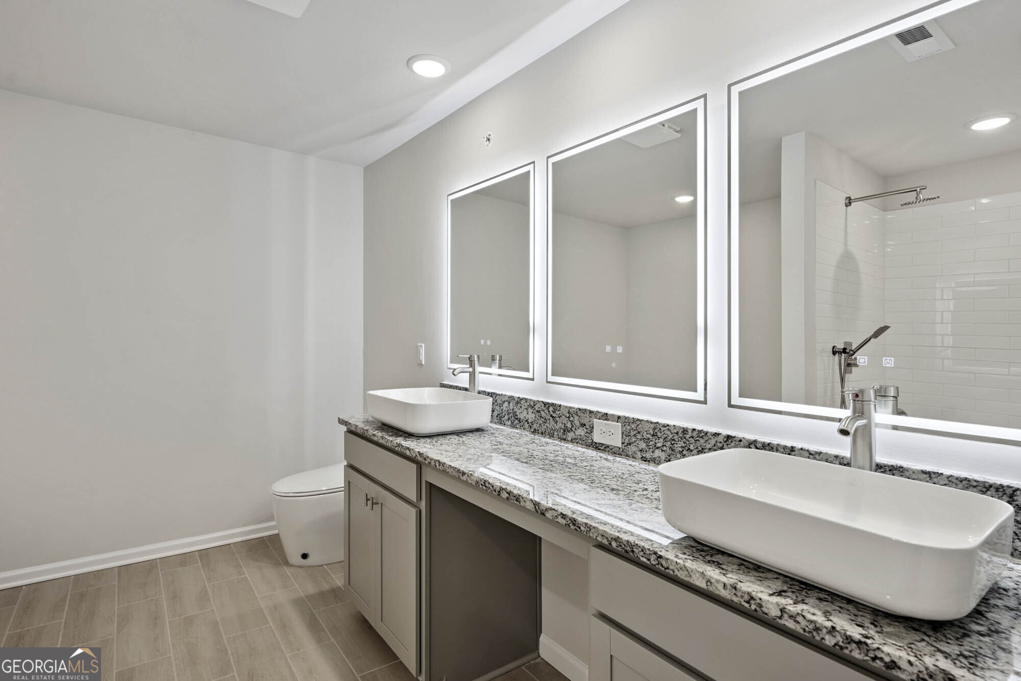 11516 Kimberly Way Hampton, GA 30228 - Photo 23 of 39 a bathroom with a granite countertop sink a toilet and a mirror