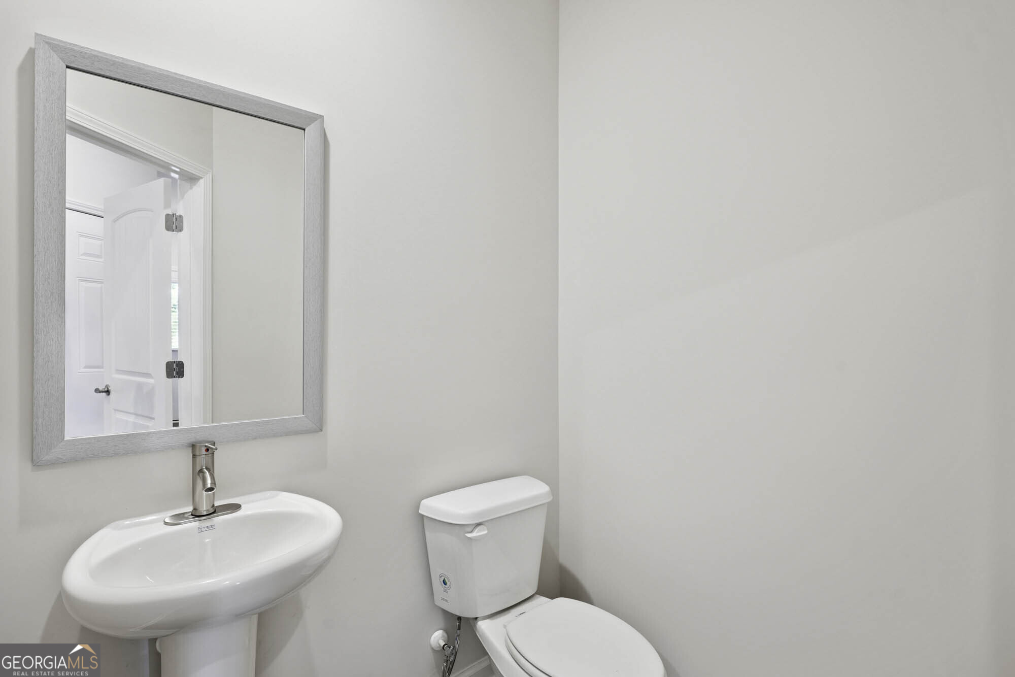 11516 Kimberly Way Hampton, GA 30228 - Photo 7 of 39 a bathroom with a toilet sink and mirror