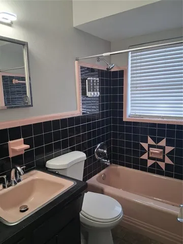 a bathroom with a sink a toilet and bathtub