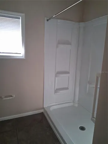 a bathroom with a glass shower door